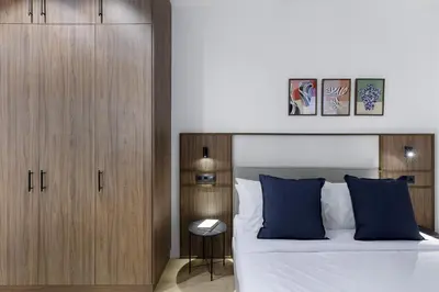 a bedroom with a large bed with blue pillows at MoRe by Zoia Living in Athens