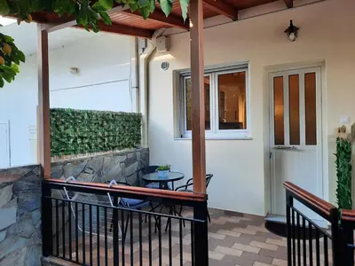 a porch with a table and a window at Athens Ellinikon Apartment in Athens