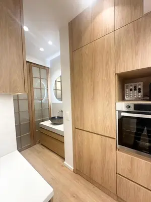 a kitchen with wooden cabinets and a stove at YPSILON Apartment in Athens