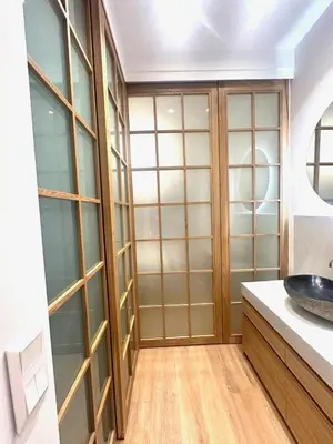 a bathroom with glass cabinets and a sink at YPSILON Apartment in Athens