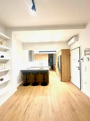 a kitchen with a counter and stools in a room at YPSILON Apartment in Athens