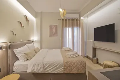 a bedroom with a bed with a flat screen tv at Althea Luxury Apt City View, Walk to Acropolis in Athens