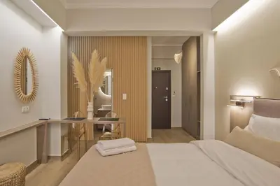 a bedroom with a bed and a desk and a mirror at Althea Luxury Apt City View, Walk to Acropolis in Athens