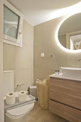 a bathroom with a toilet and a sink and a mirror at Althea Luxury Apt City View, Walk to Acropolis in Athens