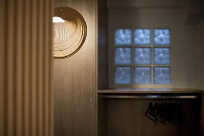 a light next to a door with a window at Althea Luxury Apt City View, Walk to Acropolis in Athens