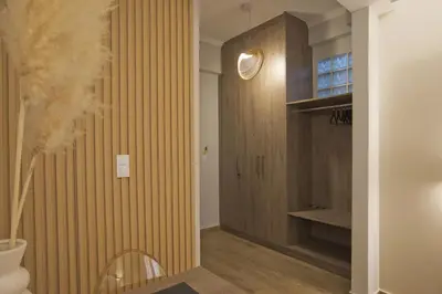 a hallway with a wood paneled wall and a staircase at Althea Luxury Apt City View, Walk to Acropolis in Athens