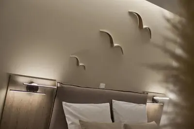 a bed with two head lights on the wall at Althea Luxury Apt City View, Walk to Acropolis in Athens