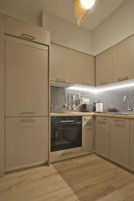 a kitchen with white cabinets and an oven in it at Althea Luxury Apt City View, Walk to Acropolis in Athens