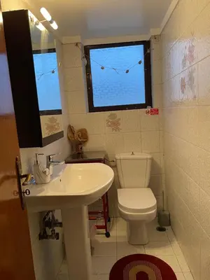 a bathroom with a toilet and a sink and a window at Konstantinia comfort studio in Athens