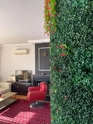 a living room with a green wall and red chairs at Konstantinia comfort studio in Athens