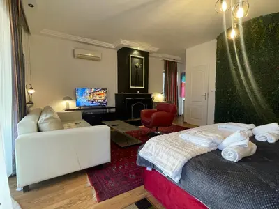 a bedroom with a bed and a living room at Konstantinia comfort studio in Athens