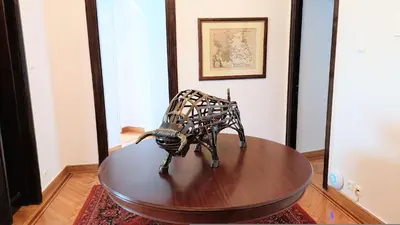 a metal sculpture on a table in a room at Grand suite in the temple of Zeus in Athens