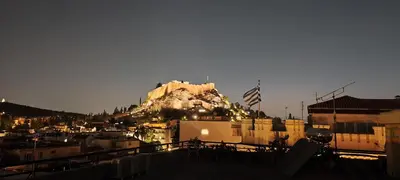 a building on top of a mountain in a city at Grand suite in the temple of Zeus in Athens