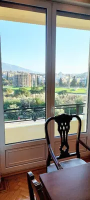 a table and chairs in front of a large window at Grand suite in the temple of Zeus in Athens