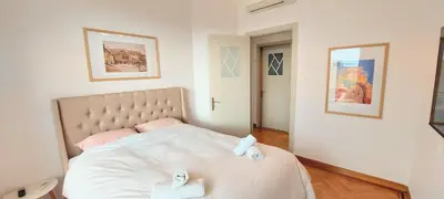 a bedroom with a bed with two towels on it at Grand suite in the temple of Zeus in Athens