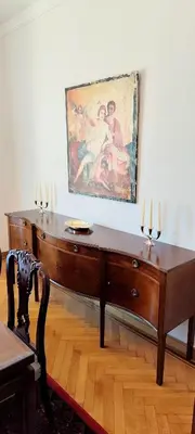 a wooden desk with a painting on the wall at Grand suite in the temple of Zeus in Athens