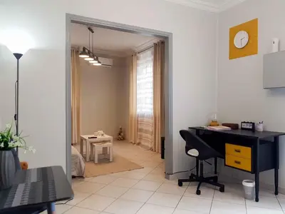 a living room with a desk and a room with a window at Athens Boutique Home in Athens