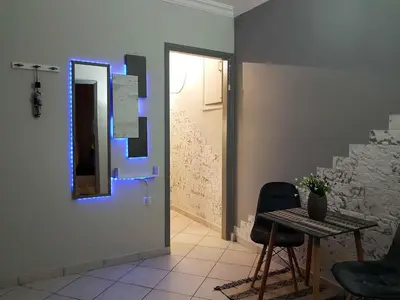 a room with a table and chairs and a blue light at Athens Boutique Home in Athens