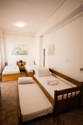 a room with three beds in it at Μεγάλο Διαμέρισμα με ευρύχωρο μπαλκόνι στην Αθήνα in Athens