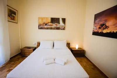 a bedroom with a large white bed with two pillows at Μεγάλο Διαμέρισμα με ευρύχωρο μπαλκόνι στην Αθήνα in Athens