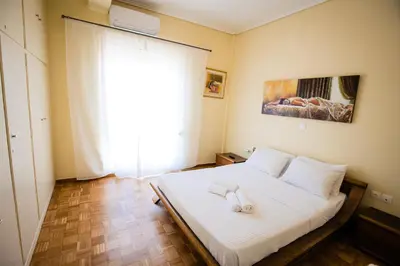 a bedroom with a bed with two towels on it at Μεγάλο Διαμέρισμα με ευρύχωρο μπαλκόνι στην Αθήνα in Athens