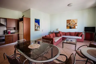 a living room with a couch and a table at Μεγάλο Διαμέρισμα με ευρύχωρο μπαλκόνι στην Αθήνα in Athens