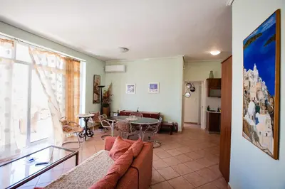 a living room with a couch and a table at Μεγάλο Διαμέρισμα με ευρύχωρο μπαλκόνι στην Αθήνα in Athens