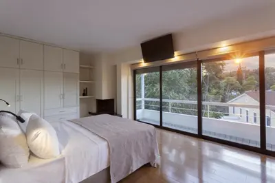 a bedroom with a white bed and a large window at Spacious 3bdr Apartment with Monumental View in Athens