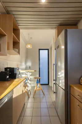 a kitchen with a refrigerator and a table in it at Spacious 3bdr Apartment with Monumental View in Athens