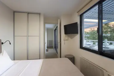a bedroom with a large window and a bed at Spacious 3bdr Apartment with Monumental View in Athens