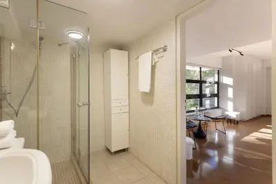 a bathroom with a shower and a toilet and a sink at Spacious 3bdr Apartment with Monumental View in Athens