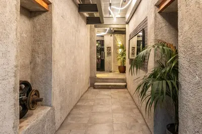 an empty hallway with plants in a building at Asomaton by Oniro in Athens