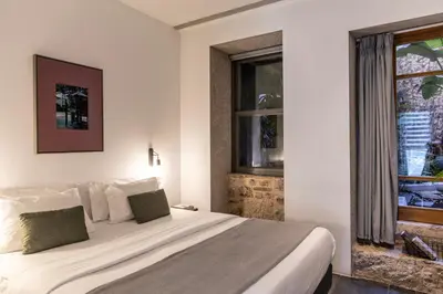 a bedroom with a large bed and a window at Asomaton by Oniro in Athens