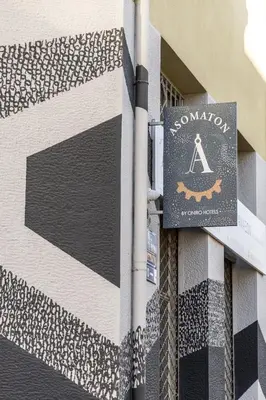 a sign on the side of a building at Asomaton by Oniro in Athens