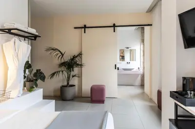 a bathroom with a sliding glass door with a sink at Asomaton by Oniro in Athens
