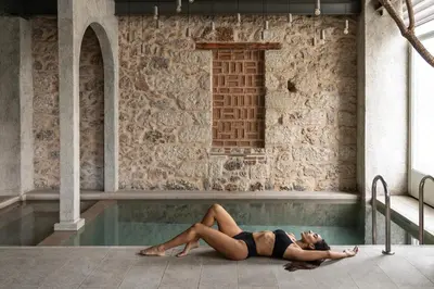 a woman laying in a swimming pool at Asomaton by Oniro in Athens