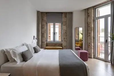a white bedroom with a large bed and large windows at Asomaton by Oniro in Athens