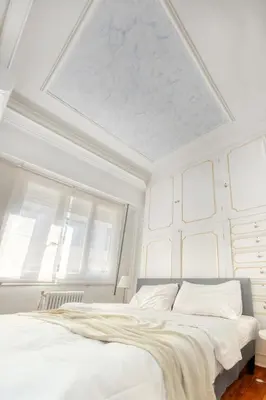 a bedroom with two beds and a ceiling with windows at Syntagma Apartment in Athens