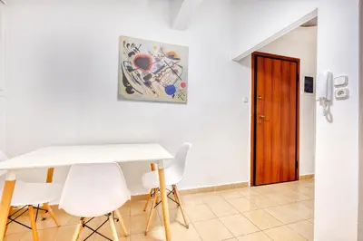 a dining room with a white table and white chairs at Syntagma Apartment in Athens