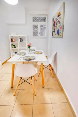 a white table and two chairs in a room at Syntagma Apartment in Athens