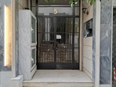 an entrance to a building with a black door at Syntagma Apartment in Athens