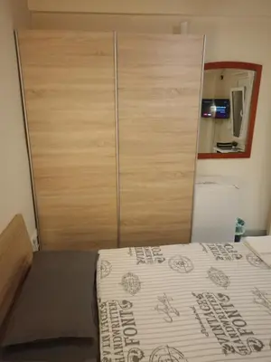 a bedroom with a bed and a wooden closet at Athens Downtown Apartment in Athens