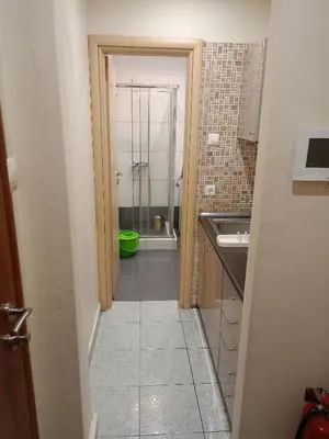 a bathroom with a shower and a sink and a toilet at Athens Downtown Apartment in Athens