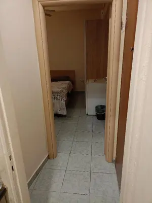 a hallway with a room with a bed and a tiled floor at Athens Downtown Apartment in Athens