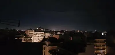 a view of a city at night with buildings at Artemis in Athens