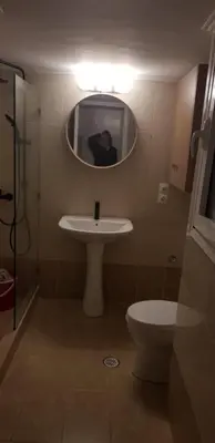 a bathroom with a sink and a mirror and a toilet at Artemis in Athens