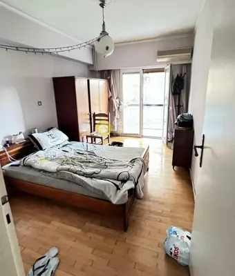 a bedroom with a bed and a wooden floor at Athens in Athens