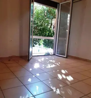 an empty room with a sliding glass door at Athens in Athens