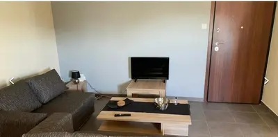 a living room with a couch and a coffee table at Athens in Athens