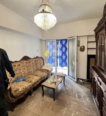 a living room with a couch and a table at Athens in Athens